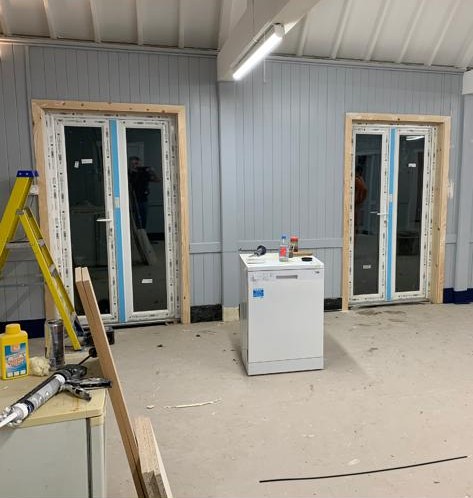 Village hall doors in and framed